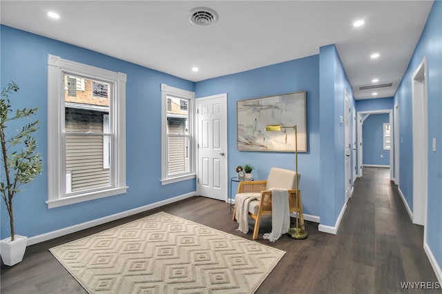 interior space featuring recessed lighting, visible vents, baseboards, and dark wood-type flooring