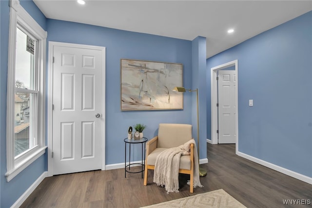 living area with recessed lighting, baseboards, and wood finished floors