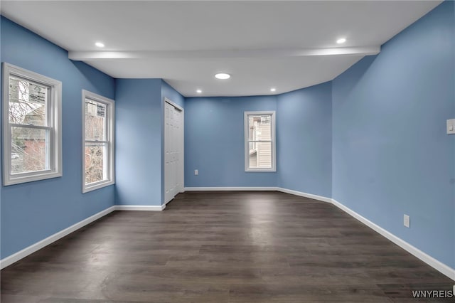 spare room with recessed lighting, baseboards, and dark wood-style flooring