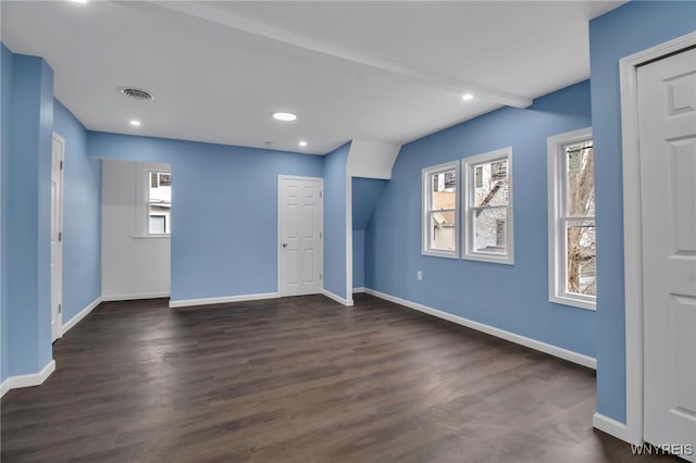 interior space featuring visible vents, baseboards, and dark wood-type flooring