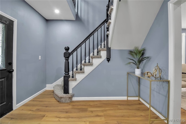 entrance foyer with stairway, recessed lighting, baseboards, and wood finished floors