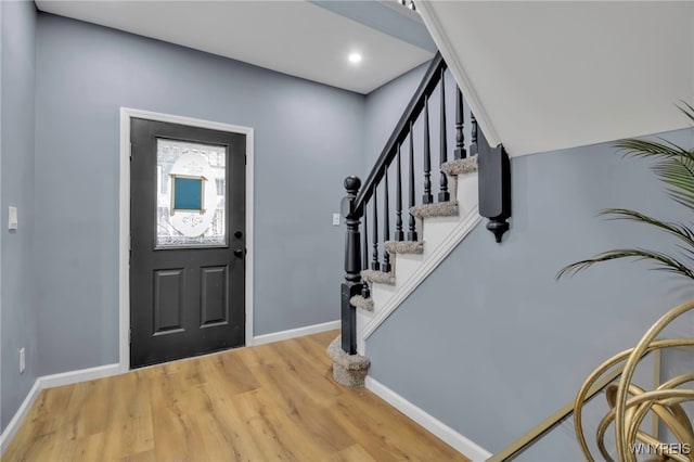 entryway with stairway, recessed lighting, baseboards, and light wood-style floors