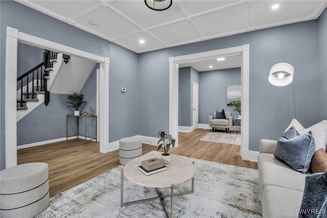 living area featuring stairs, recessed lighting, wood finished floors, and baseboards