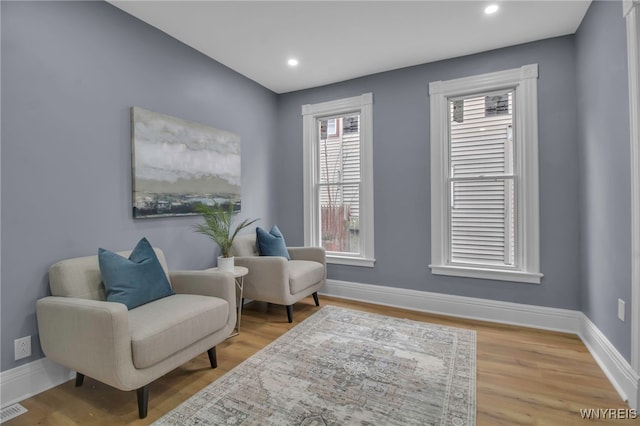 sitting room with visible vents, recessed lighting, baseboards, and wood finished floors