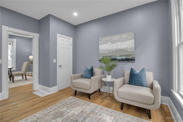 sitting room featuring baseboards and wood finished floors