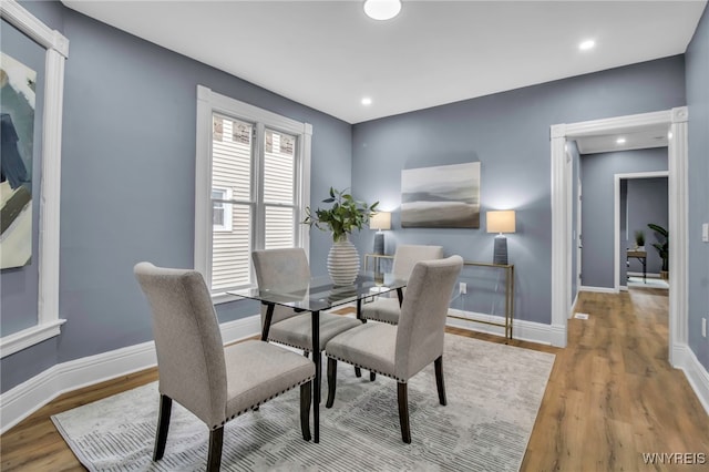 dining room with recessed lighting, wood finished floors, and baseboards