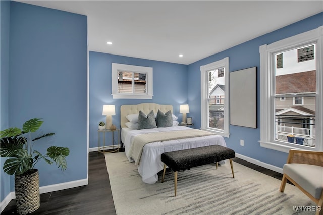 bedroom with recessed lighting, baseboards, and wood finished floors