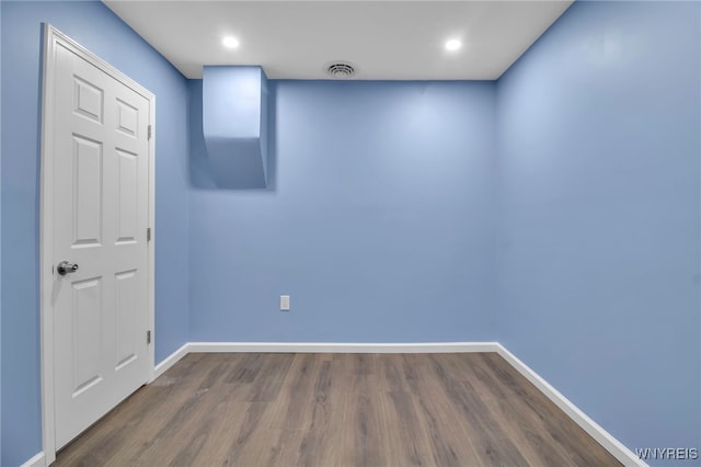 unfurnished room with visible vents, recessed lighting, baseboards, and wood finished floors