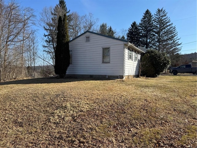 view of side of home featuring a yard