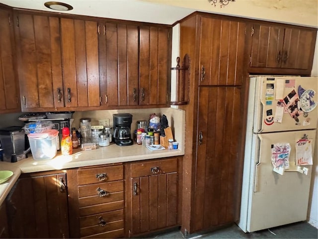 kitchen featuring light countertops and freestanding refrigerator