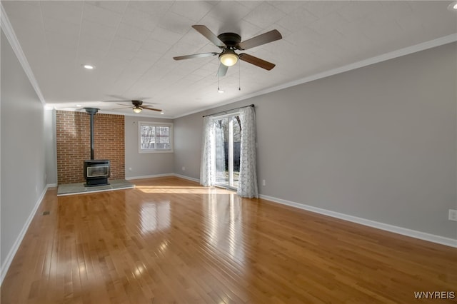 unfurnished living room featuring crown molding, light wood-type flooring, a wood stove, and ceiling fan