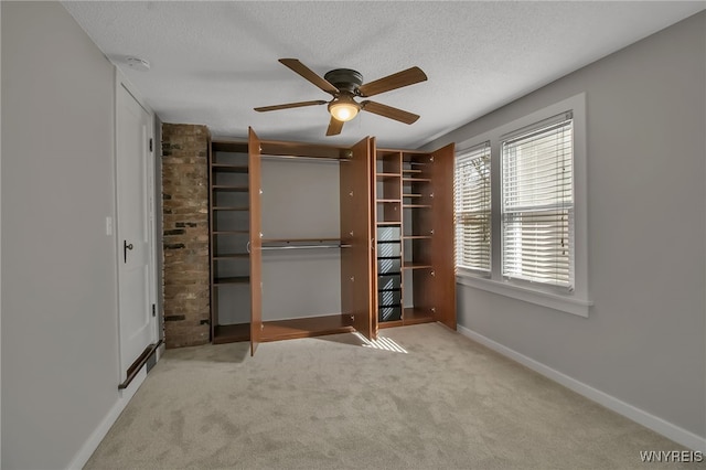 unfurnished bedroom featuring a closet, baseboards, carpet, and a textured ceiling