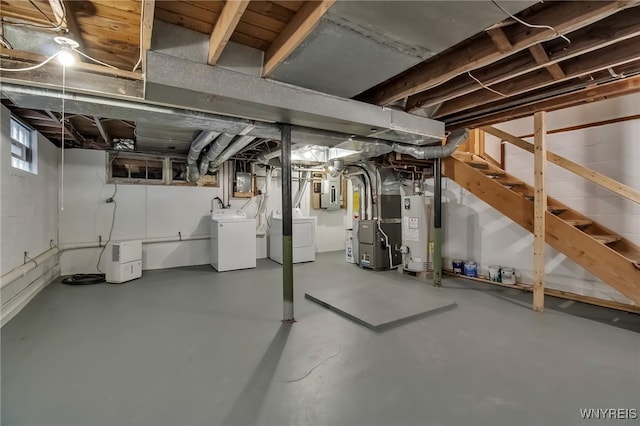 basement with electric panel, heating unit, washing machine and dryer, gas water heater, and stairway