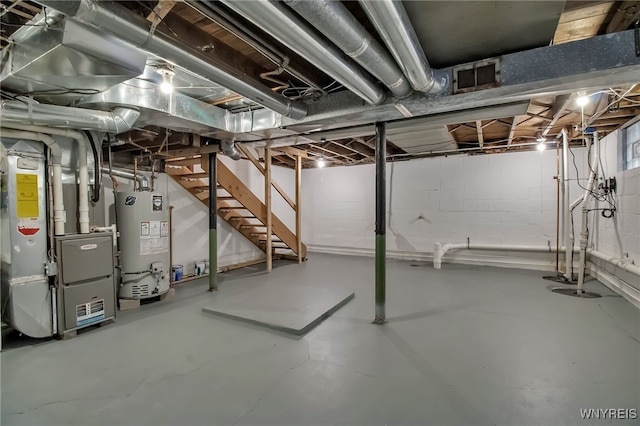 unfinished basement featuring stairway, heating unit, and water heater