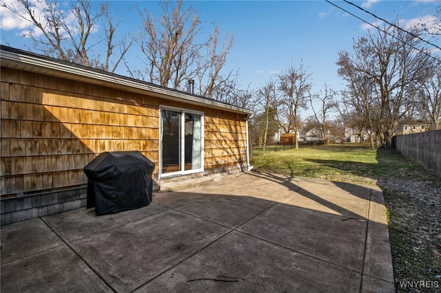 view of patio / terrace with fence and a grill