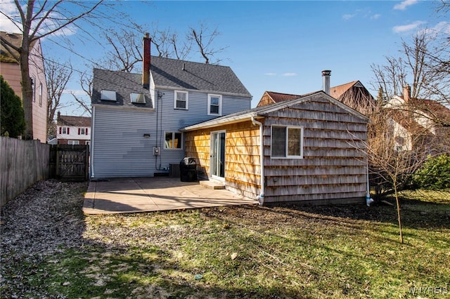 back of house with a patio area and fence