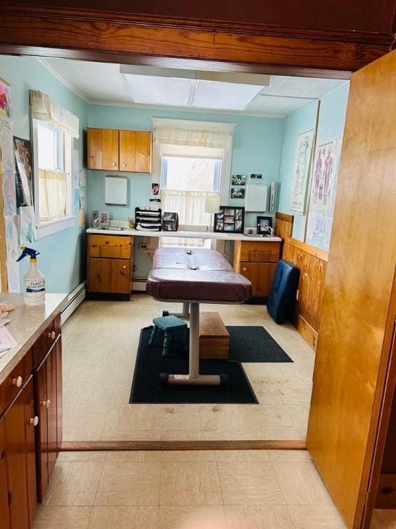 kitchen with brown cabinets, light countertops, and a healthy amount of sunlight