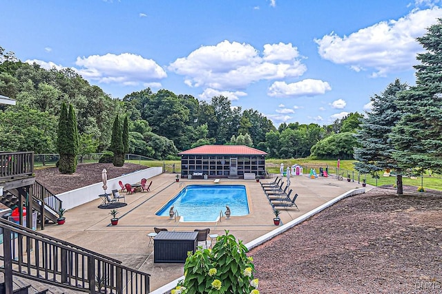 community pool featuring a patio and fence