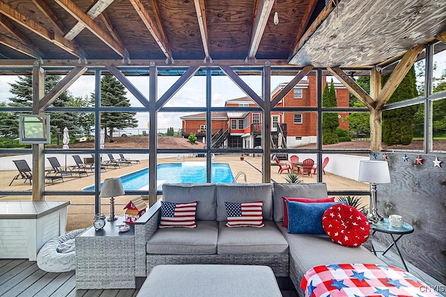 pool with an outdoor living space and glass enclosure