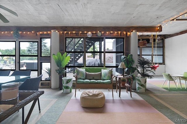 sunroom / solarium featuring a ceiling fan