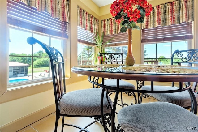 tiled dining room with baseboards