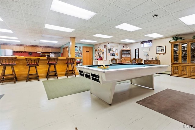 game room featuring billiards, a dry bar, and a paneled ceiling