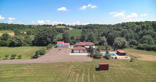 bird's eye view featuring a rural view and a wooded view