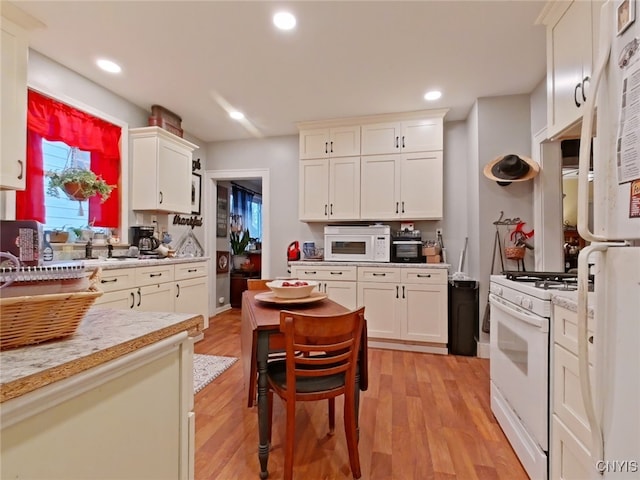 1644 Saint Agnes Ave, Utica, NY 13501 - kitchen with light stone countertops, recessed lighting, white appliances, light wood finished floors, and white cabinets