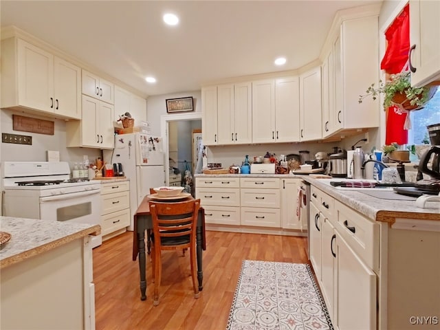 1644 Saint Agnes Ave, Utica, NY 13501 - kitchen with recessed lighting, light countertops, light wood finished floors, and white appliances