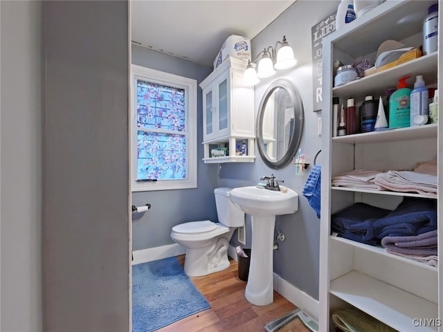 1644 Saint Agnes Ave, Utica, NY 13501 - bathroom featuring toilet, baseboards, and wood finished floors