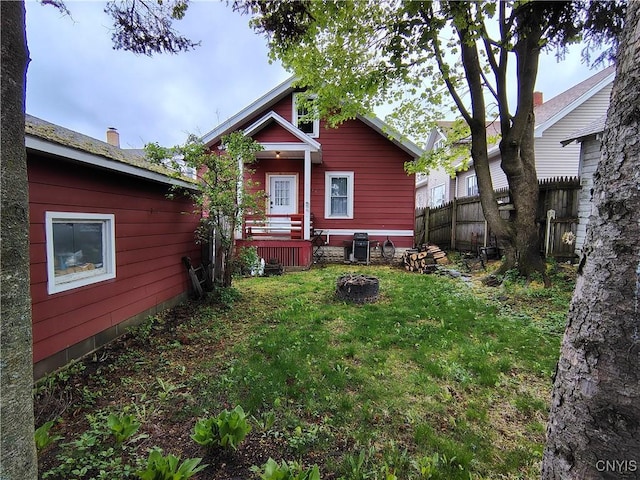 1644 Saint Agnes Ave, Utica, NY 13501 - rear view of house with a lawn and fence