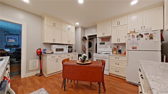 1644 Saint Agnes Ave, Utica, NY 13501 - kitchen featuring light wood-style floors, stacked washer and dryer, white appliances, and light countertops
