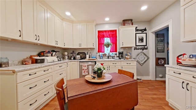 1644 Saint Agnes Ave, Utica, NY 13501 - kitchen with stainless steel dishwasher, light wood-style floors, recessed lighting, light countertops, and white cabinets