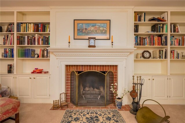 123 Sunset Ridge Rd, Otsego, NY 13326 - sitting room featuring a brick fireplace, carpet flooring, and built in shelves