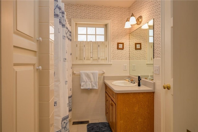 123 Sunset Ridge Rd, Otsego, NY 13326 - bathroom with wallpapered walls, a wainscoted wall, vanity, tile patterned floors, and tile walls