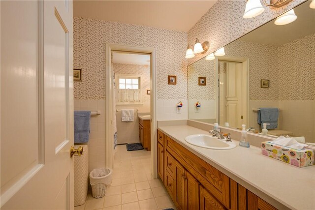 123 Sunset Ridge Rd, Otsego, NY 13326 - bathroom with wallpapered walls, tile walls, tile patterned floors, vanity, and a wainscoted wall