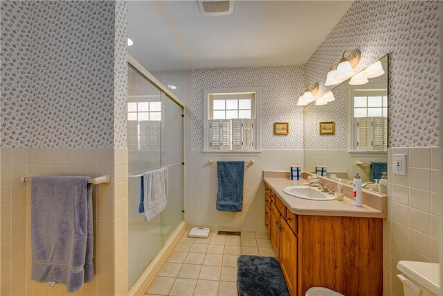 123 Sunset Ridge Rd, Otsego, NY 13326 - bathroom with wallpapered walls, tile walls, tile patterned floors, vanity, and a shower stall