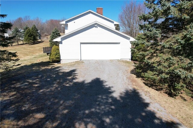 123 Sunset Ridge Rd, Otsego, NY 13326 - view of side of property with a chimney, driveway, and a garage