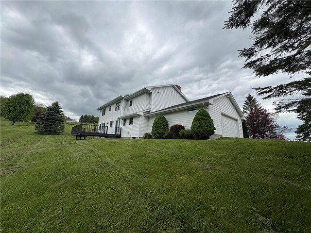 123 Sunset Ridge Rd, Otsego, NY 13326 - view of side of home with a garage, a deck, and a lawn