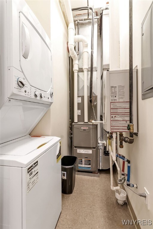 clothes washing area featuring laundry area and stacked washer and clothes dryer