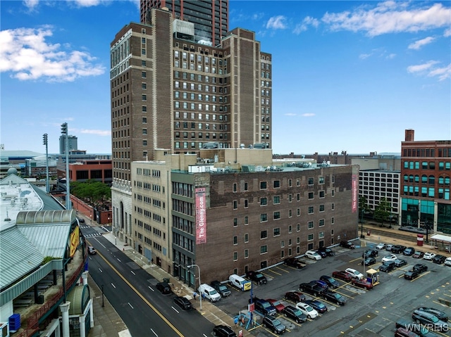 view of building exterior featuring a view of city and uncovered parking