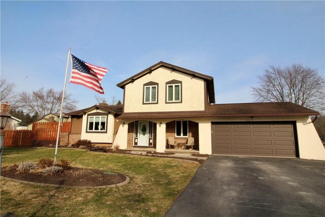traditional home featuring stucco siding, a front lawn, driveway, fence, and a garage