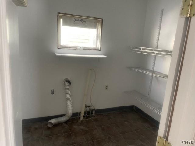 laundry area with baseboards and laundry area