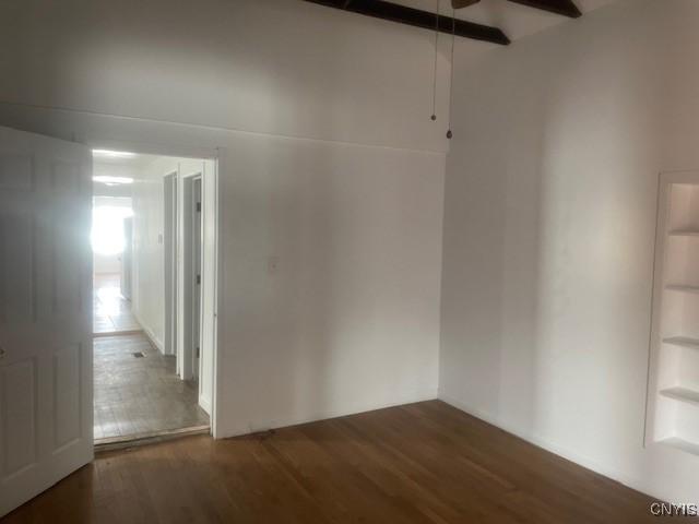 spare room with ceiling fan and wood finished floors