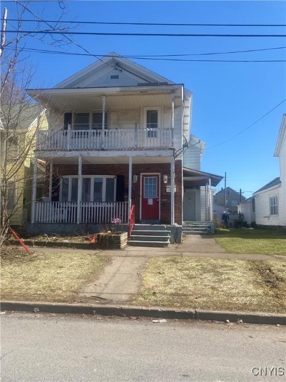 view of front facade featuring a balcony and covered porch