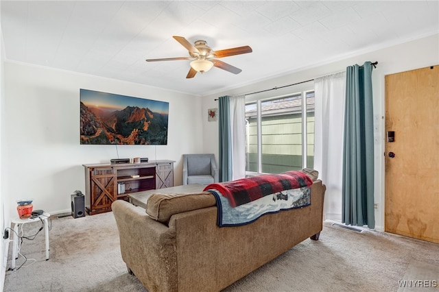 living area with baseboards, carpet, ceiling fan, and crown molding