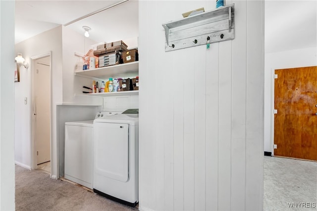 laundry room featuring laundry area, separate washer and dryer, and light carpet