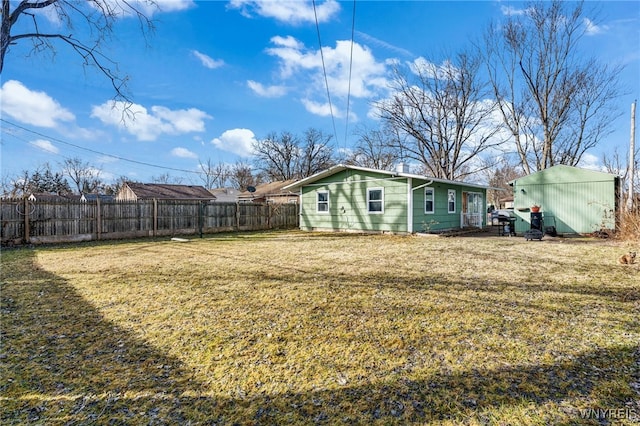 view of yard featuring an outbuilding and fence