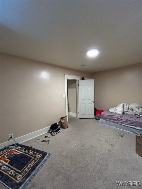 unfurnished bedroom featuring carpet and baseboards