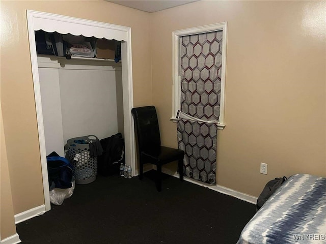 bedroom with baseboards and a closet